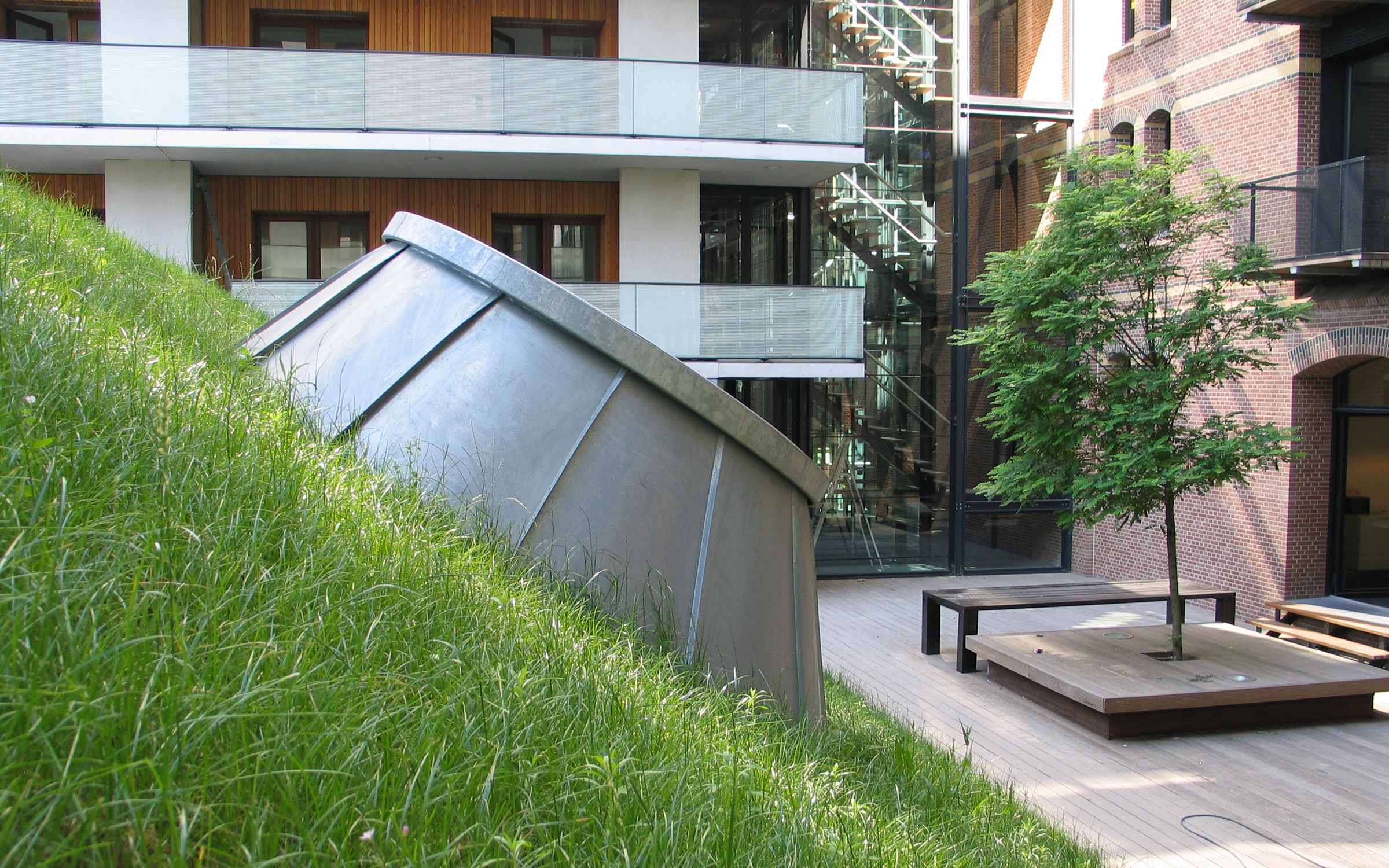 Skylights allow for natural daylight inside the  building. Pitched green roof with skylights